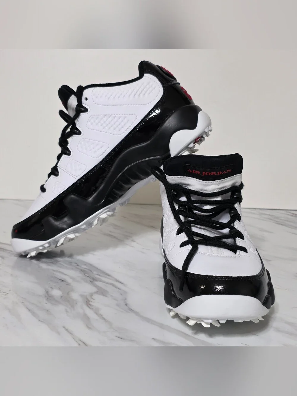 Jordan White and Black Golf Cleats with Red Logo